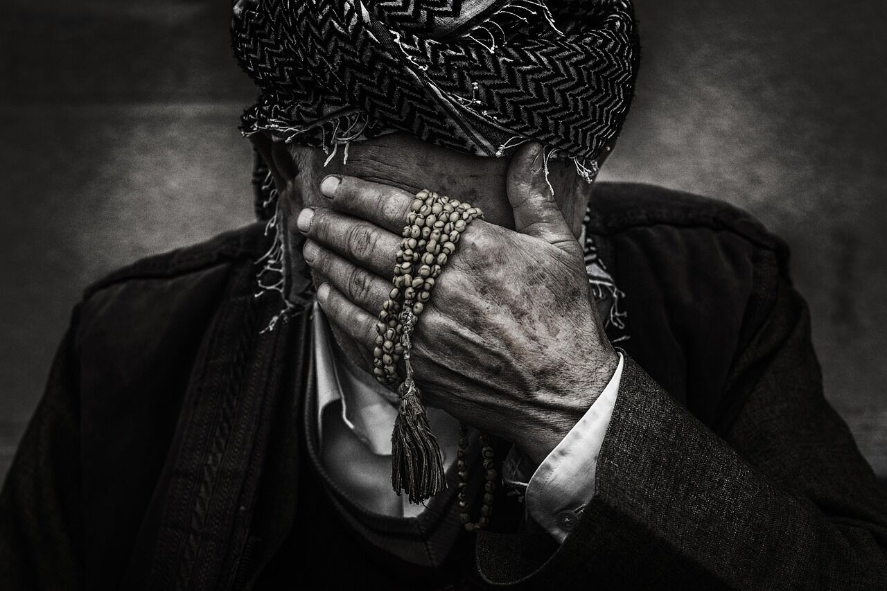 An older man appearing contemplative and withdrawn, emphasizing the isolation depression can bring.