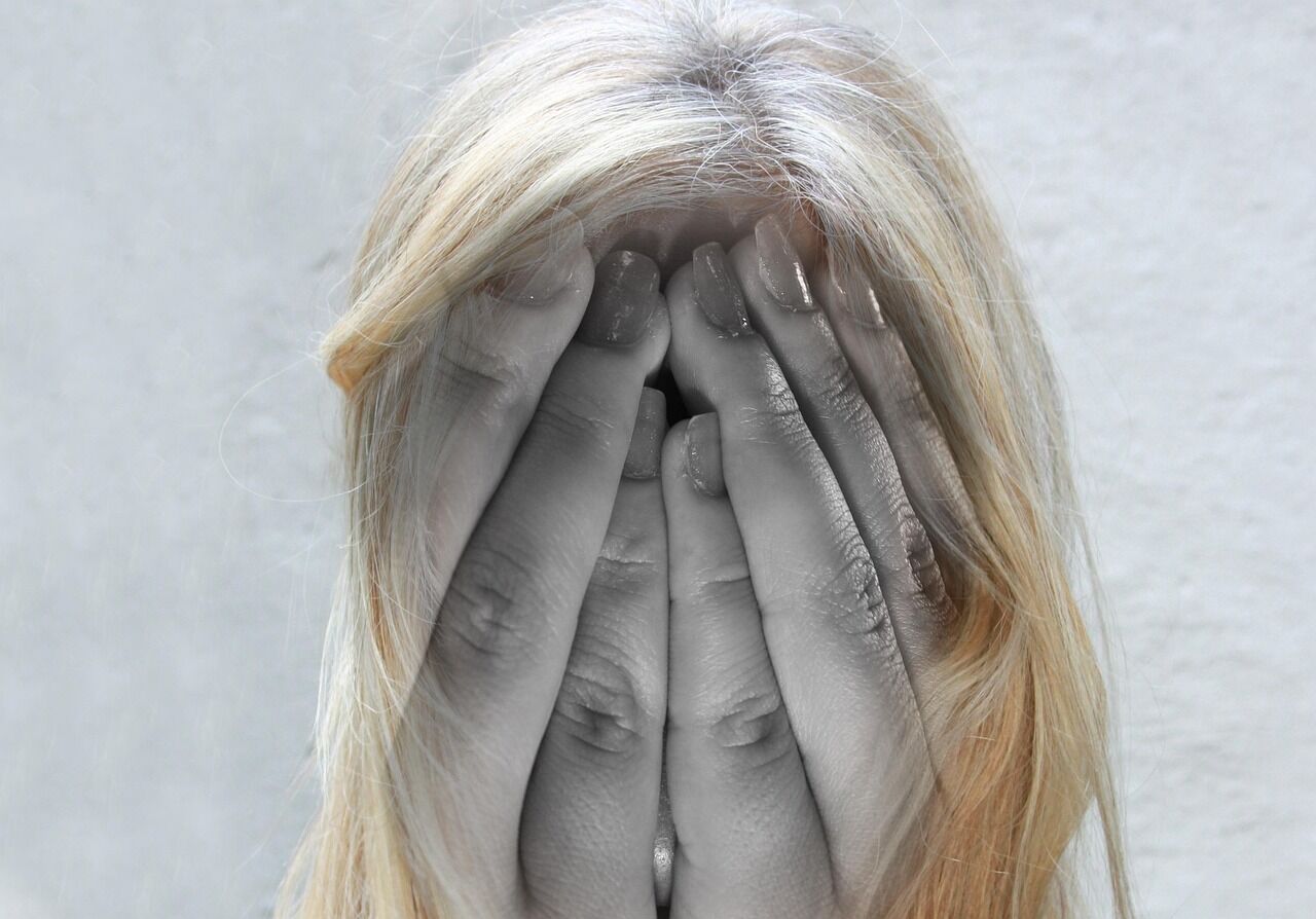 A woman looking thoughtful, perhaps contemplating support systems for mental health